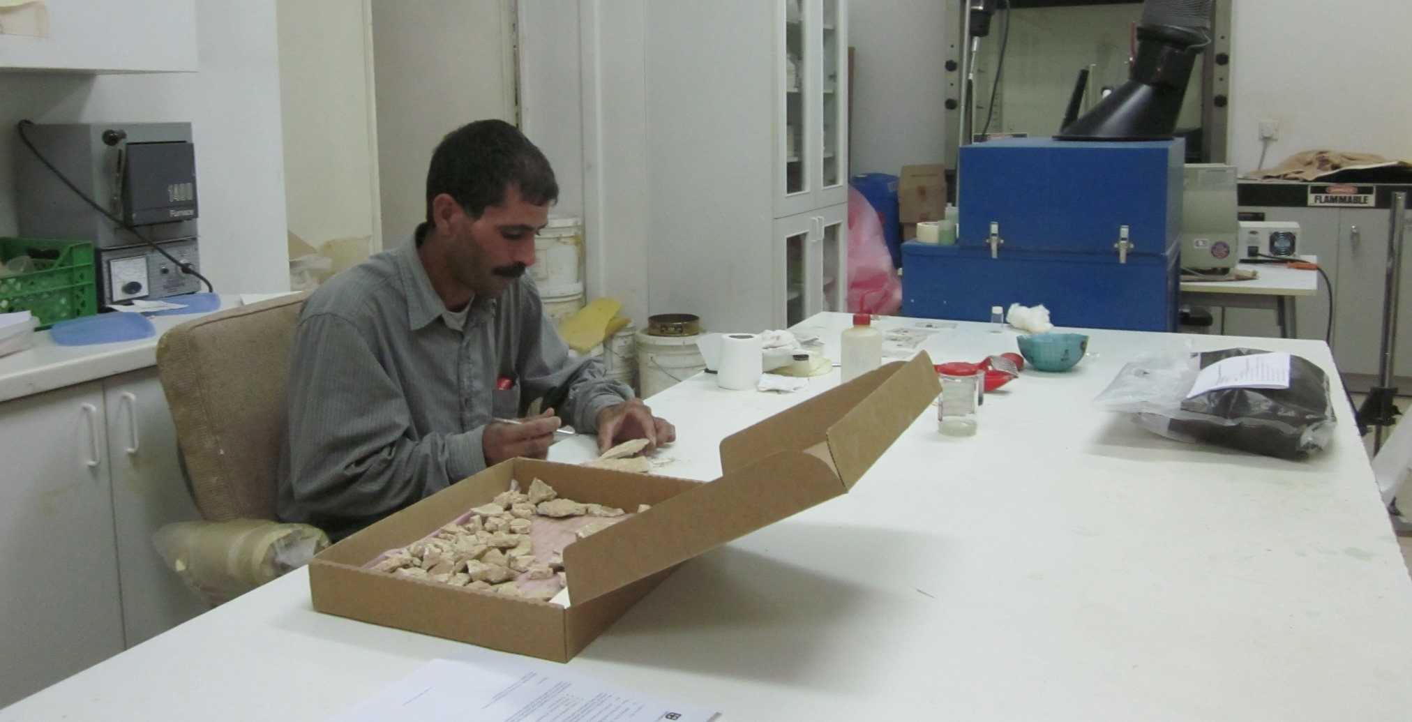 Naif Zaban in the ACOR Conservation Lab treating wall plaster fragments found in the Ayn Gharandal fort by the University of Tennessee team under Robert and Erin Darby. Photo by Barbara A. Porter.